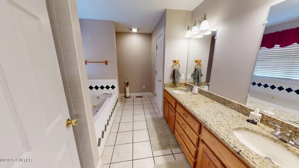 a bathroom with a bathtub and a window