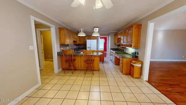 a kitchen with stainless steel appliances granite countertop a sink a stove counter space and cabinets