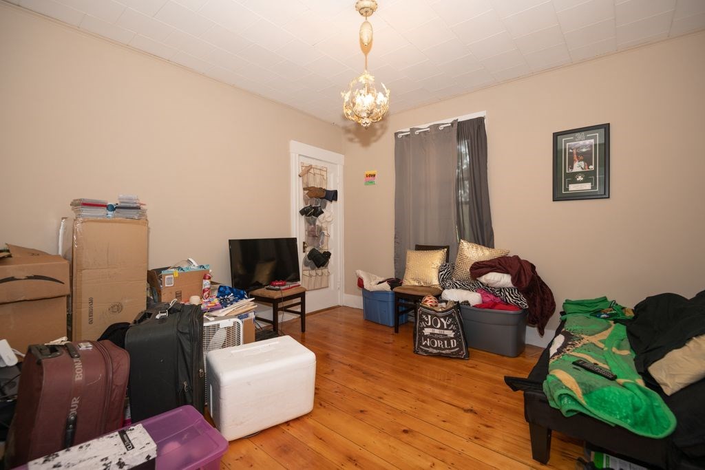 39 King Philip Road Worcester, MA 01606 - Photo 11 of 13 a living room with furniture a flat screen tv and a chandelier