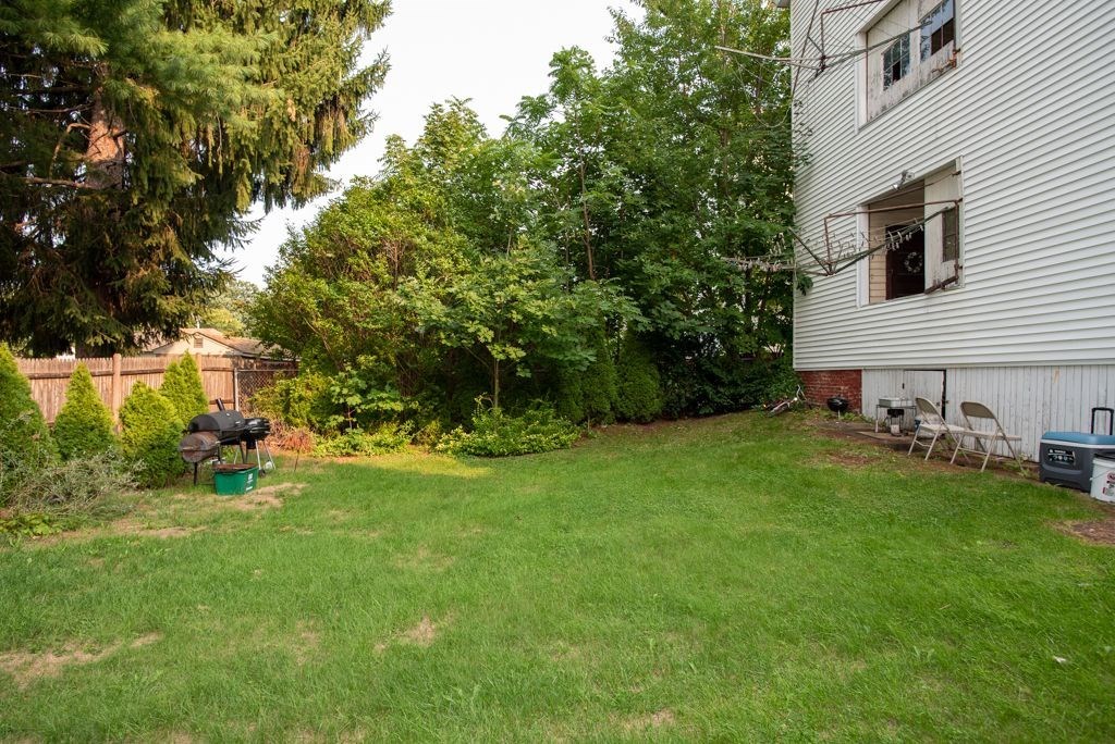 39 King Philip Road Worcester, MA 01606 - Photo 12 of 13 a view of a backyard with plants and a garden