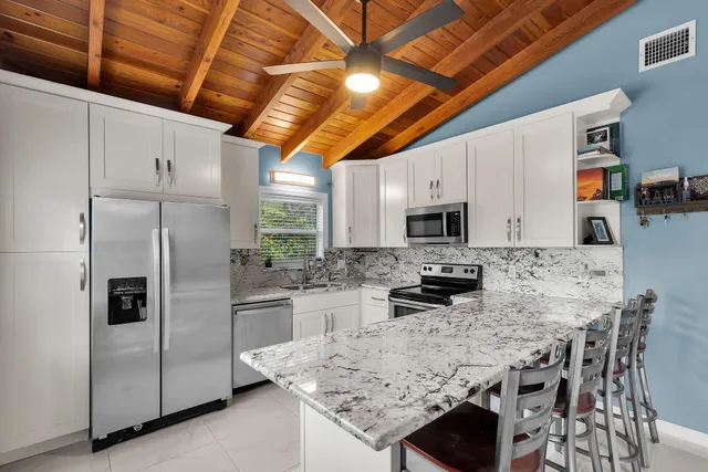 a kitchen with stainless steel appliances granite countertop a stove and a sink