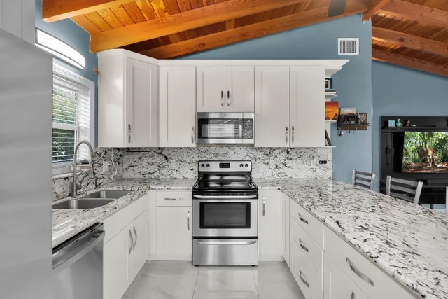 a kitchen with a sink and large window