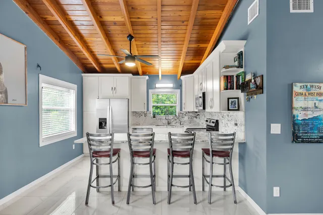 a kitchen with stainless steel appliances granite countertop a stove refrigerator sink and cabinets