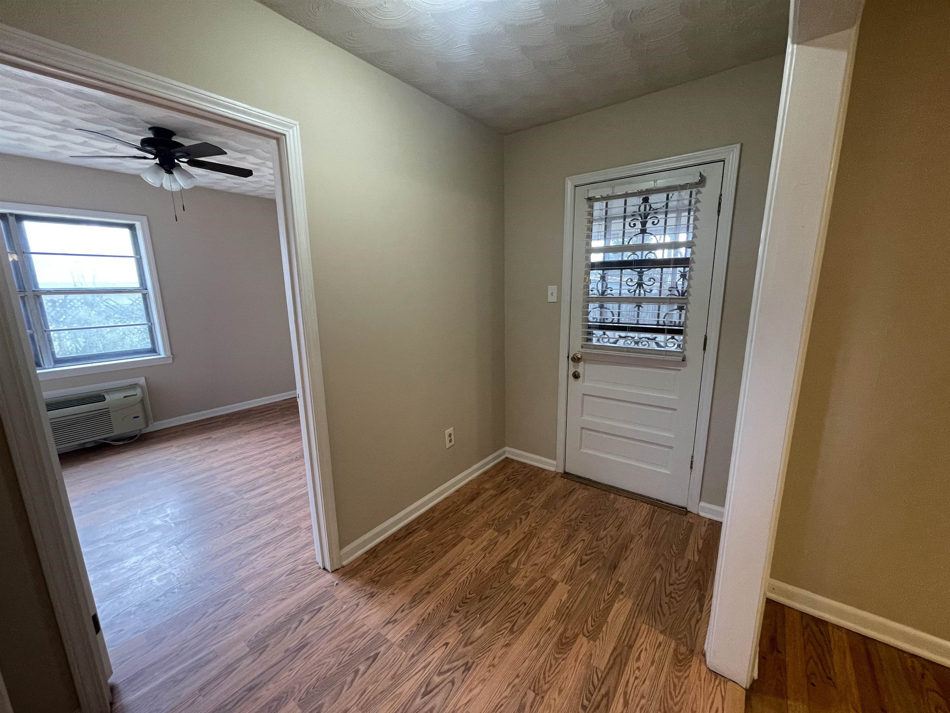 1626 Wheaton Street Memphis, TN 38117 - Photo 3 of 12 an empty room with wooden floor closet and windows