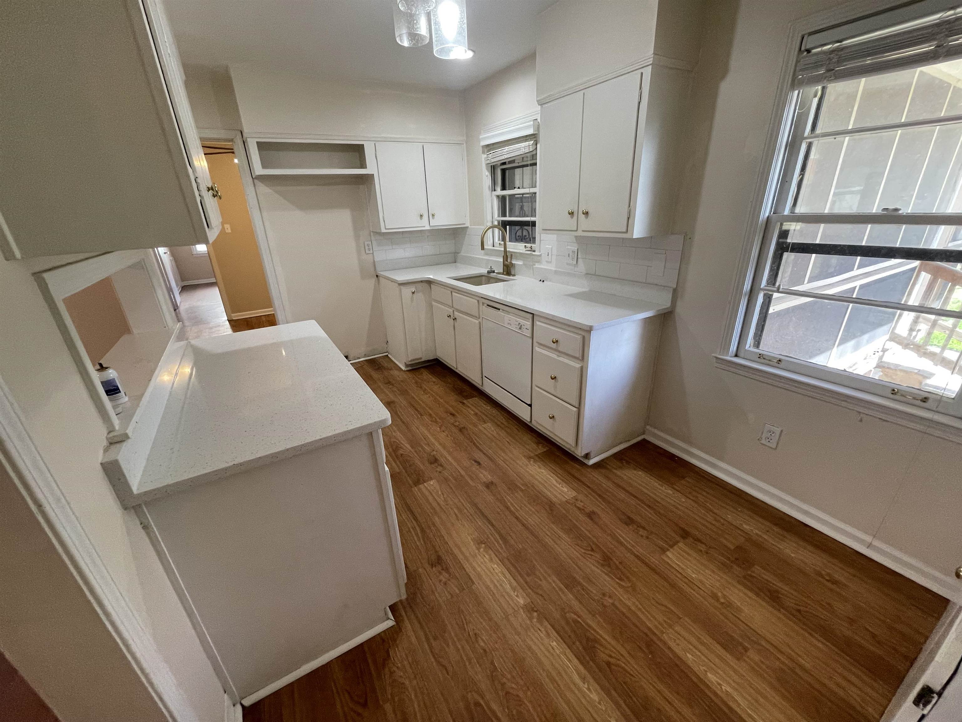 1626 Wheaton Street Memphis, TN 38117 - Photo 4 of 12 a kitchen with sink microwave and refrigerator