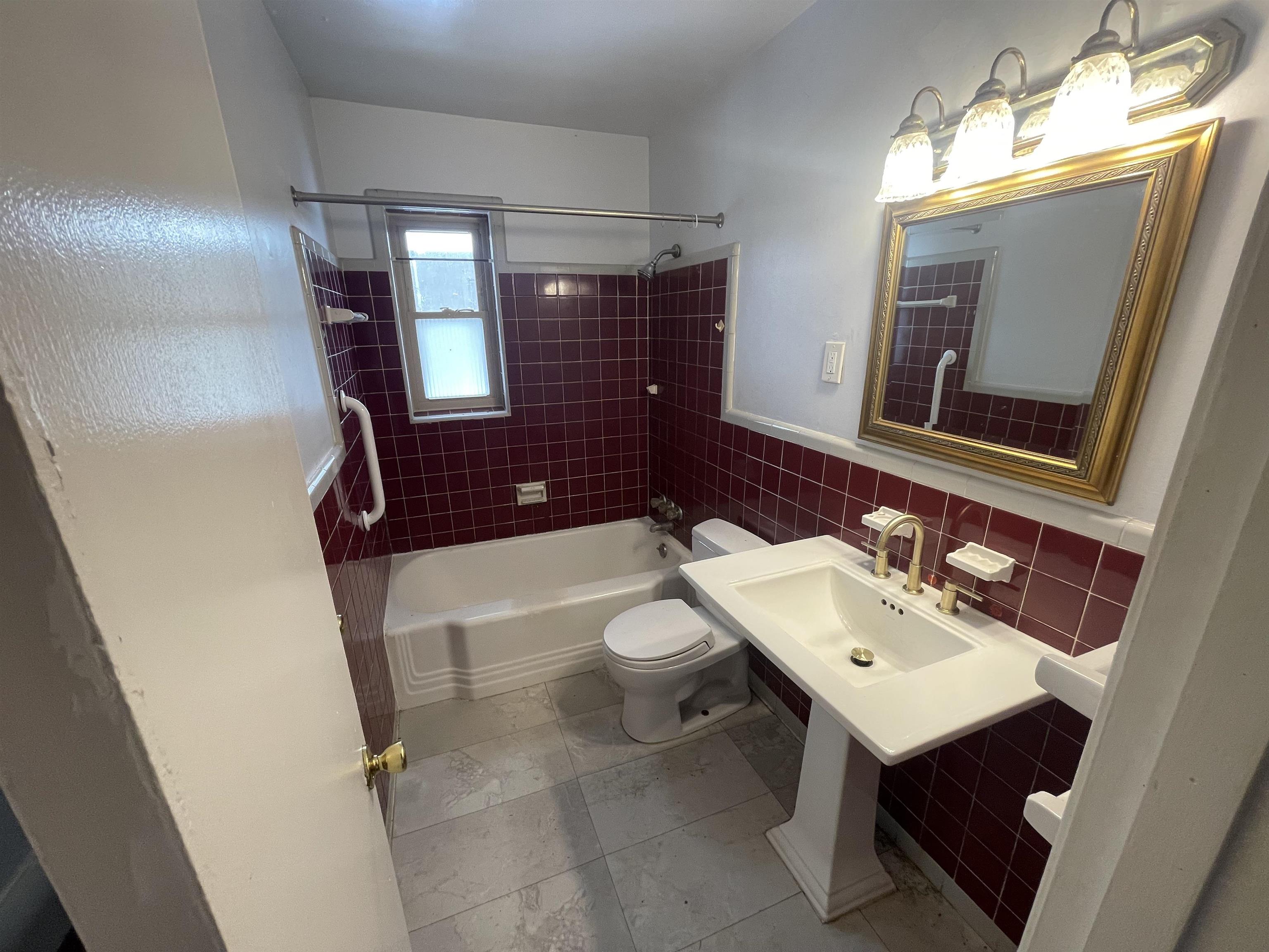 1626 Wheaton Street Memphis, TN 38117 - Photo 6 of 12 a bathroom with a toilet sink and mirror