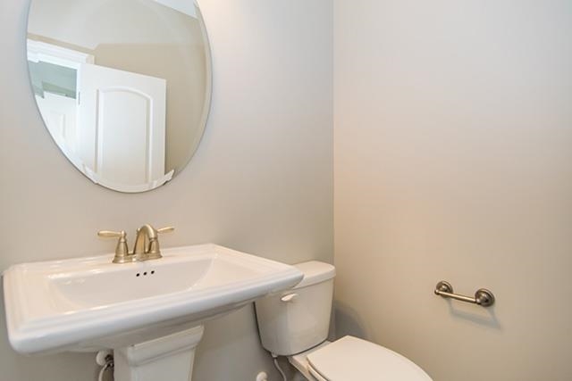 3501 Bloomfield Way Raleigh, NC 27616 - Photo 12 of 25 a bathroom with a toilet a sink and mirror
