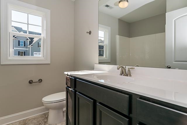 3501 Bloomfield Way Raleigh, NC 27616 - Photo 15 of 25 a bathroom with a granite countertop sink a large mirror a toilet and a window