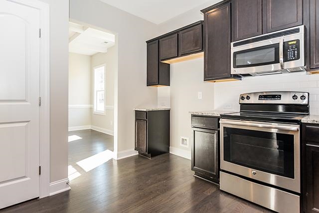 3501 Bloomfield Way Raleigh, NC 27616 - Photo 4 of 25 a kitchen with stainless steel appliances a stove microwave and sink