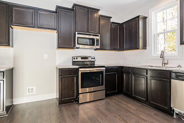 3501 Bloomfield Way Raleigh, NC 27616 - Photo 5 of 25 a kitchen with stainless steel appliances a stove a sink and a microwave