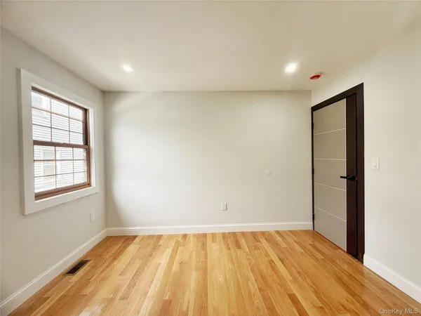 a bathroom with a sink a toilet a window and vanity
