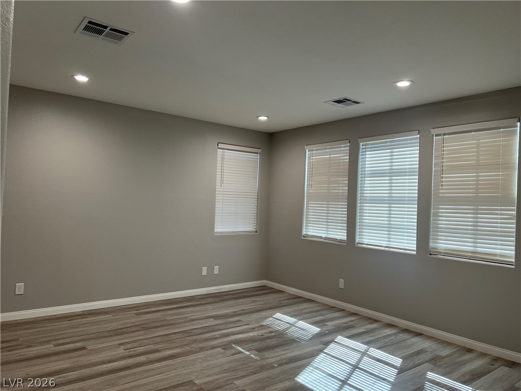 5981 Honeysuckle Ridge Street Las Vegas, NV 89148 - Photo 13 of 29 Recessed lighting illuminates this versatile room with ample window light.