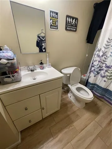 a bathroom with a sink mirror vanity and toilet
