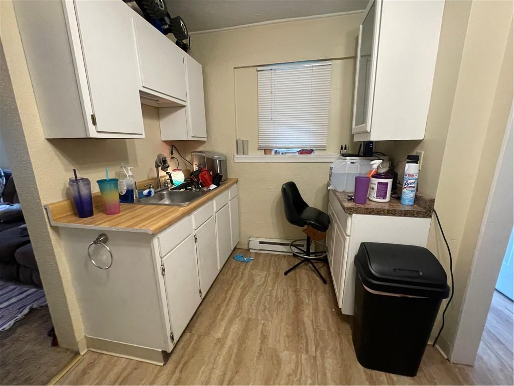 102 Francis Mine State Road Burgettstown, PA 15021 - Photo 3 of 18 a kitchen with a refrigerator a stove a sink dishwasher and white cabinets with wooden floor