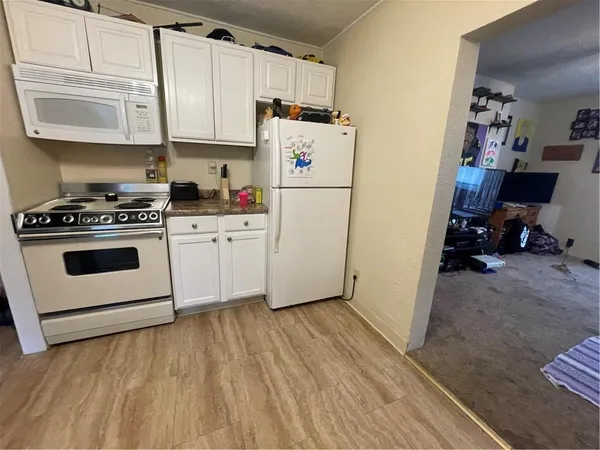 a white refrigerator freezer sitting inside of a kitchen