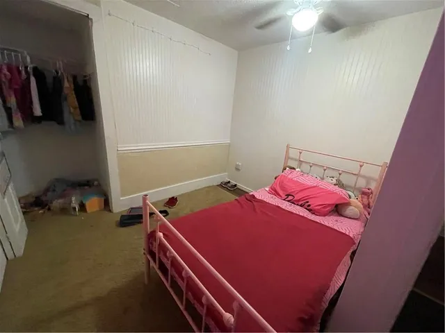a room with storage and a bed