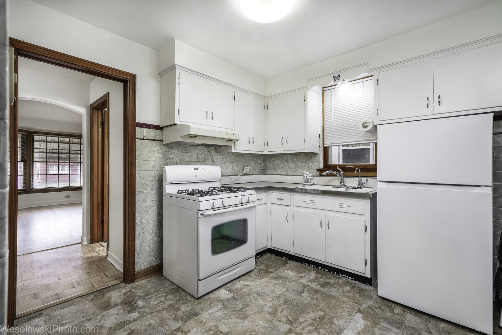 5944 West Foster Avenue Chicago, IL 60630 - Photo 6 of 21 a kitchen with granite countertop cabinets appliances and a sink