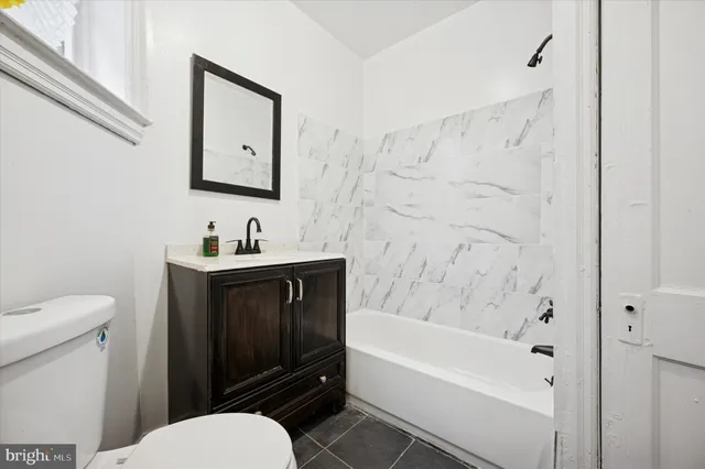 a bathroom with a sink a toilet and bathtub