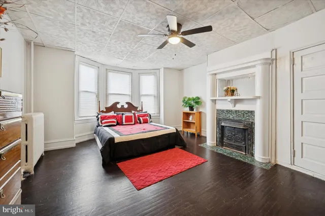 a bedroom with furniture and a fireplace