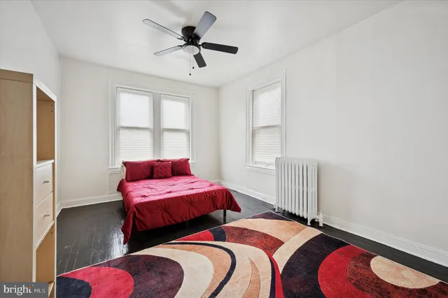 a bedroom with two beds and a chandelier
