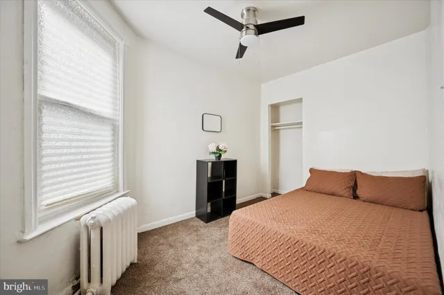 a bedroom with a bed and a window