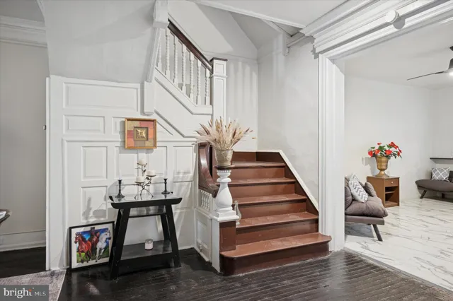 a view of entryway with wooden floor and stairs