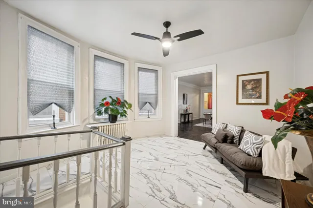 a living room with furniture and a large window