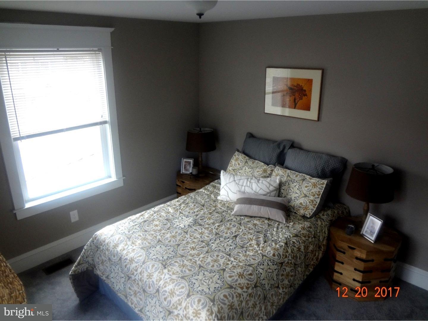 324 Lenox Road Havertown, PA 19083 - Photo 12 of 25 a bed sitting in a bedroom next to a window