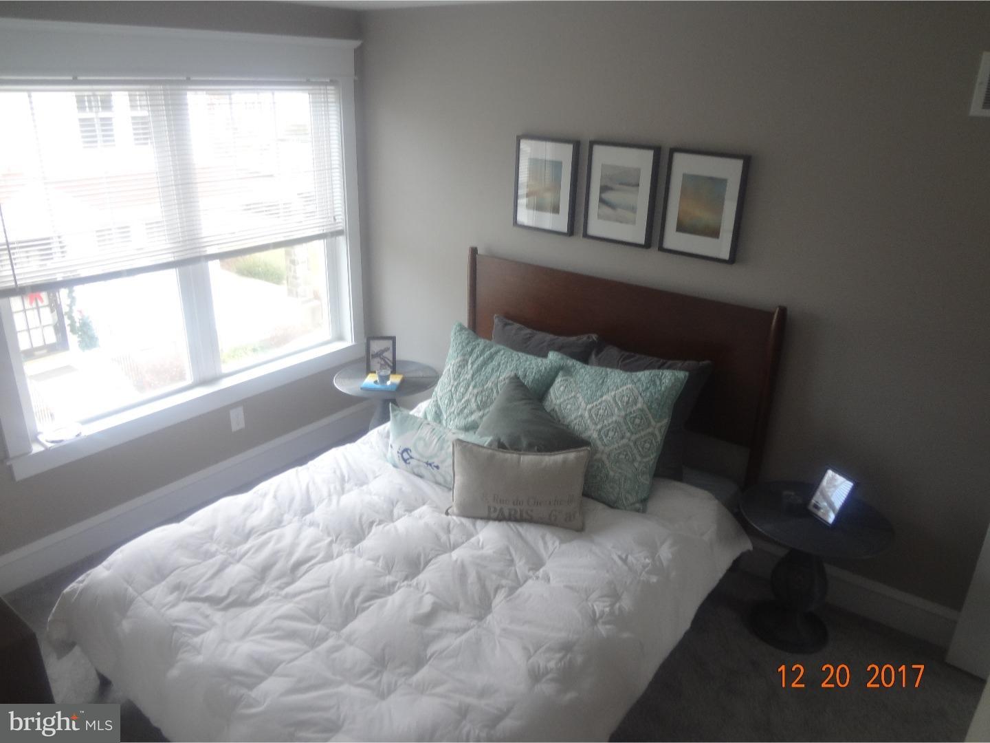 324 Lenox Road Havertown, PA 19083 - Photo 14 of 25 a bed sitting in a bedroom next to a window