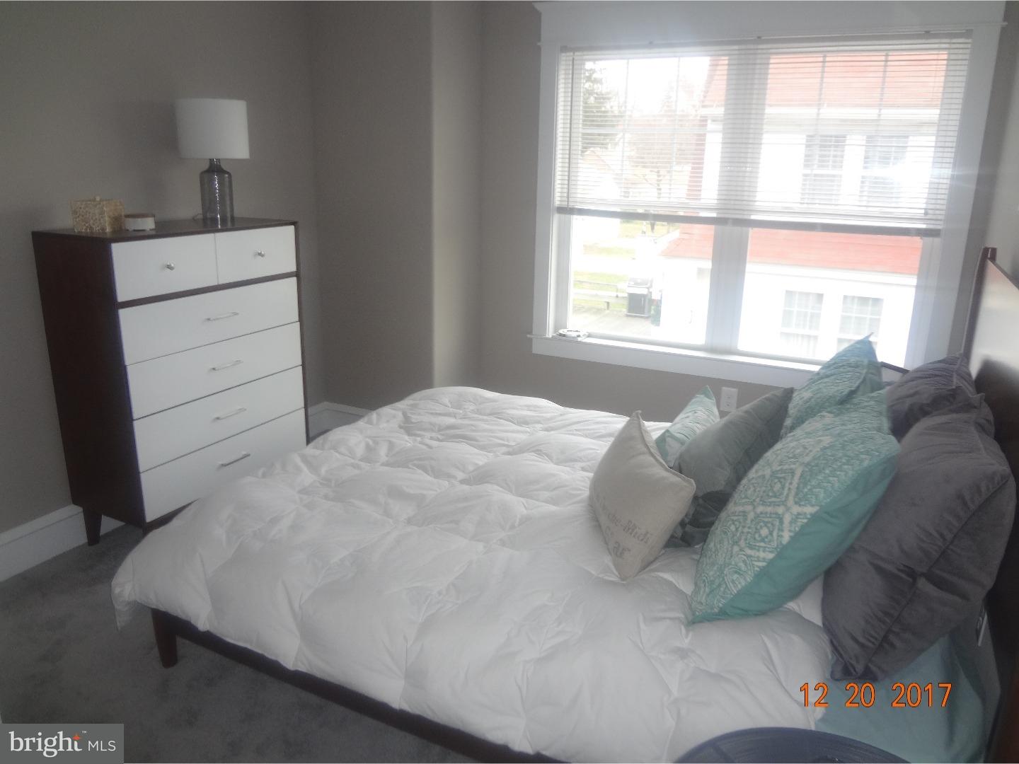 324 Lenox Road Havertown, PA 19083 - Photo 15 of 25 a bed sitting in a bedroom next to a window and dresser
