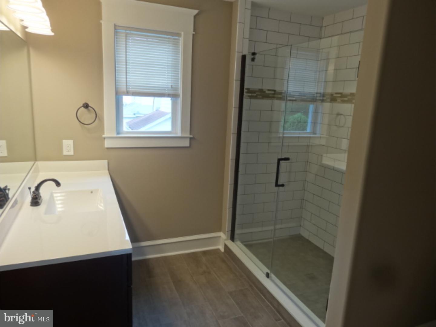 324 Lenox Road Havertown, PA 19083 - Photo 19 of 25 a bathroom with a sink a shower and a mirror