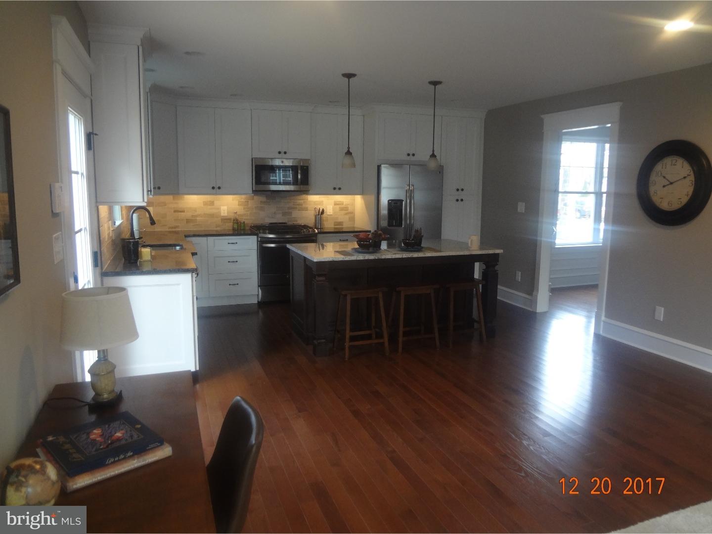 324 Lenox Road Havertown, PA 19083 - Photo 3 of 25 a kitchen with stainless steel appliances granite countertop a stove a refrigerator a sink a dining table and chairs with wooden floor