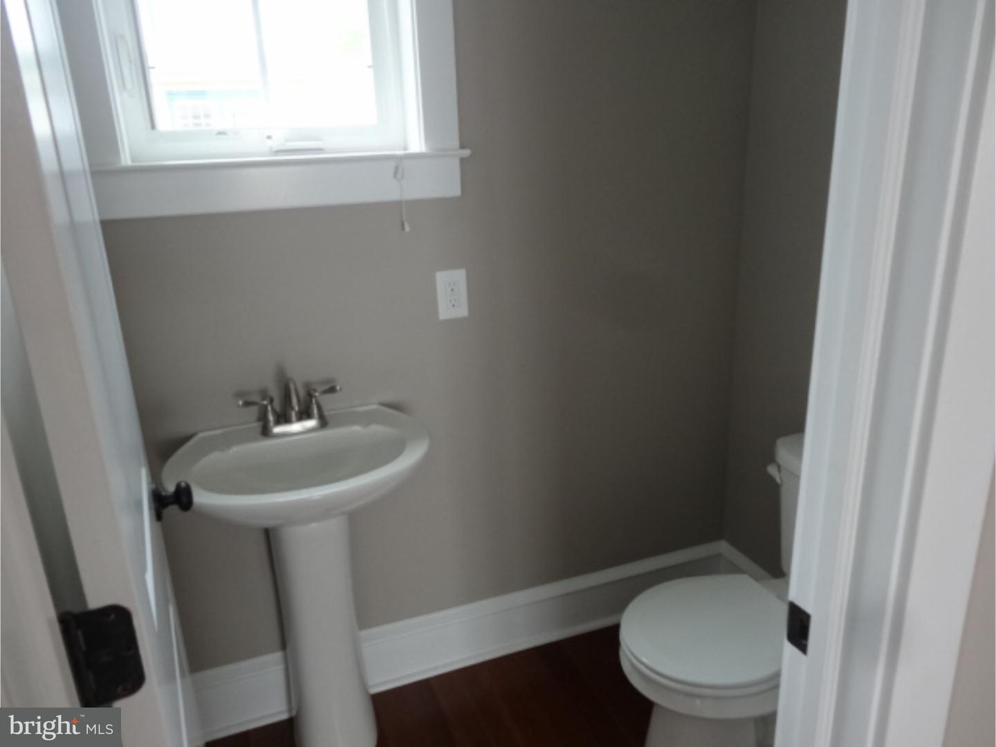 324 Lenox Road Havertown, PA 19083 - Photo 4 of 25 a white toilet sitting next to a bathroom sink
