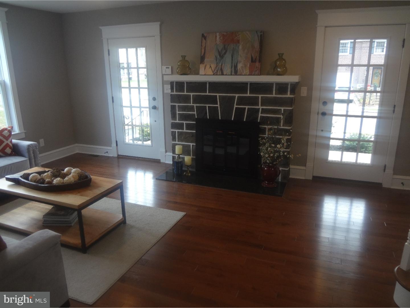 324 Lenox Road Havertown, PA 19083 - Photo 5 of 25 a living room with furniture a fireplace and a window