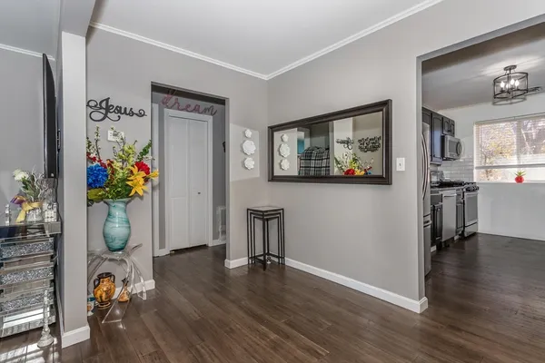 a view of a workspace room with wooden floor and a ceiling fan