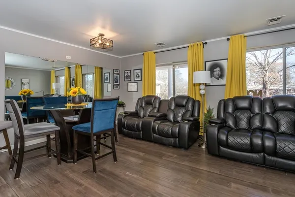 a living room with furniture and a chandelier