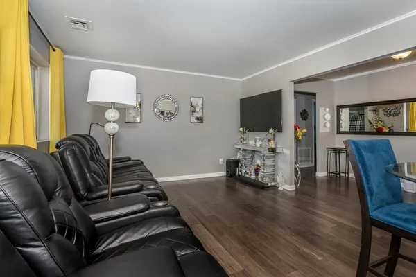 a living room with furniture and wooden floor