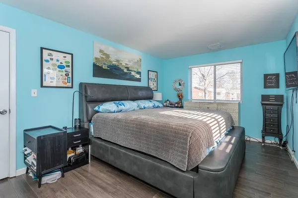 a bed sitting in a bedroom next to a window