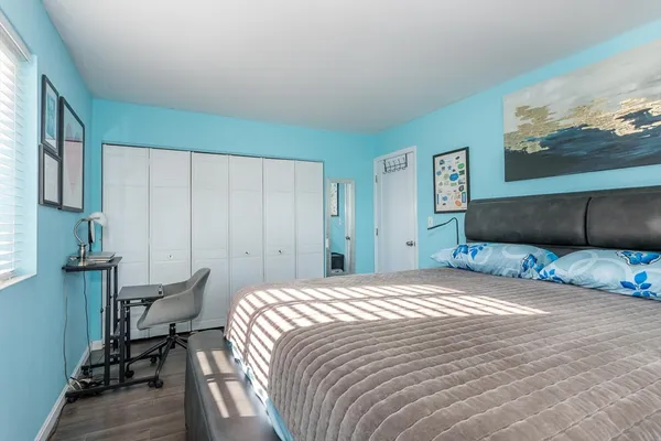 a bedroom with a bed and a chair