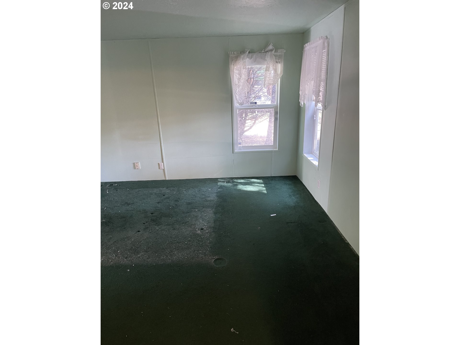 55096 Harrison Road Southwest Bandon, OR 97411 - Photo 15 of 34 a view of an empty room with windows