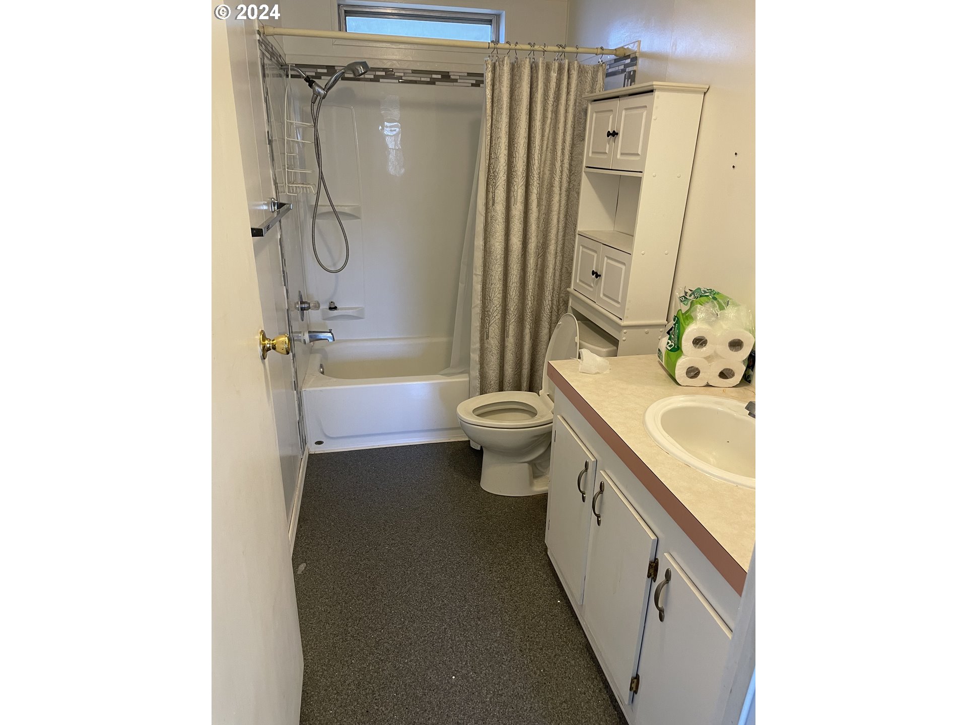 55096 Harrison Road Southwest Bandon, OR 97411 - Photo 23 of 34 a bathroom with a granite countertop sink a toilet a mirror and shower