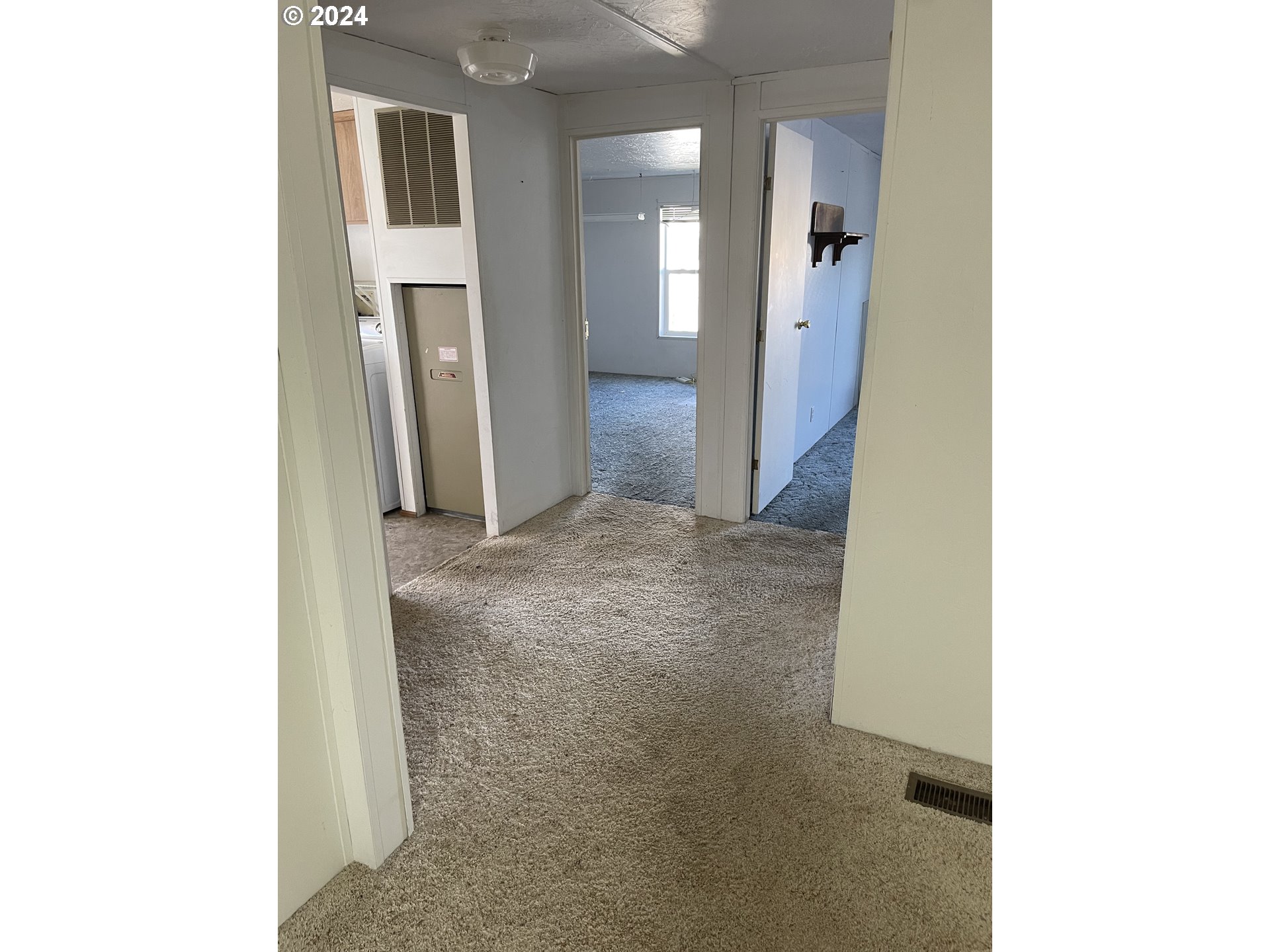 55096 Harrison Road Southwest Bandon, OR 97411 - Photo 8 of 34 a view of a hallway with wooden cabinets