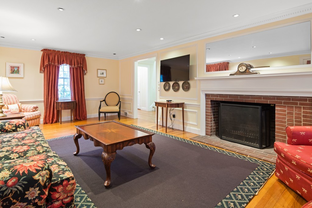 21 Fairway Road Brookline, MA 02467 - Photo 4 of 30 a living room with furniture a flat screen tv and a fireplace