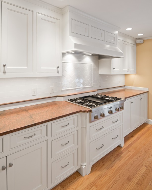 21 Fairway Road Brookline, MA 02467 - Photo 8 of 30 a kitchen with granite countertop white cabinets and a stove