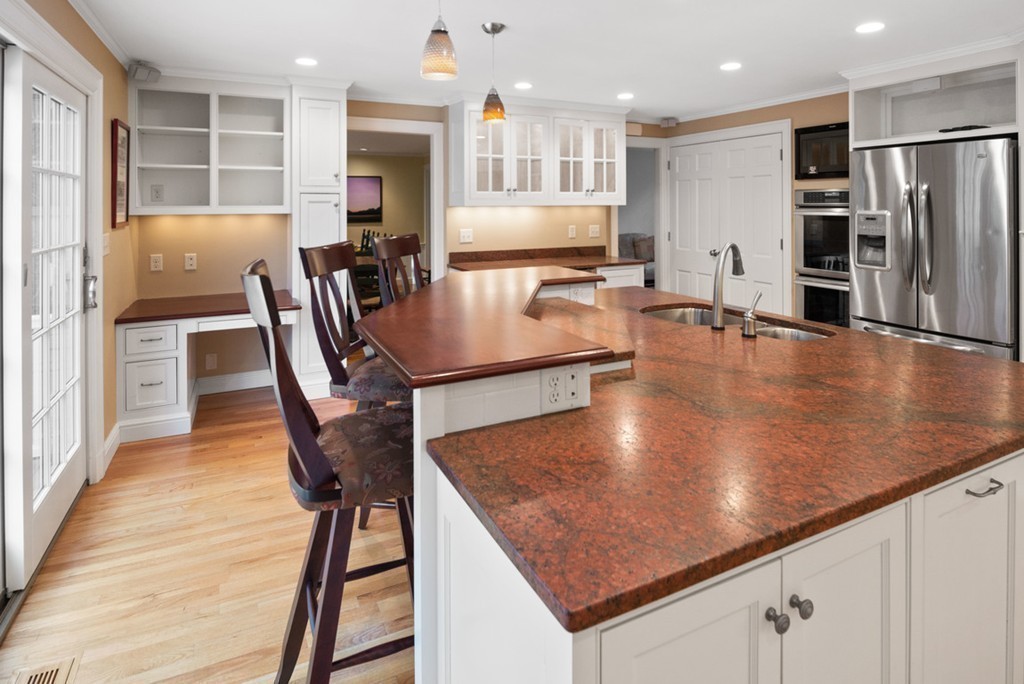 21 Fairway Road Brookline, MA 02467 - Photo 9 of 30 a large kitchen with stainless steel appliances granite countertop a sink a table and chairs