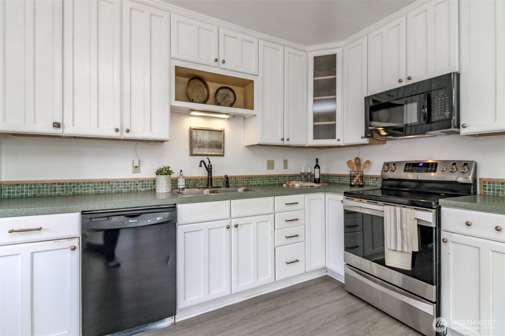 1514 Rainier Street Steilacoom, WA 98388 - Photo 12 of 37 a kitchen with stainless steel appliances granite countertop a stove a sink and a microwave