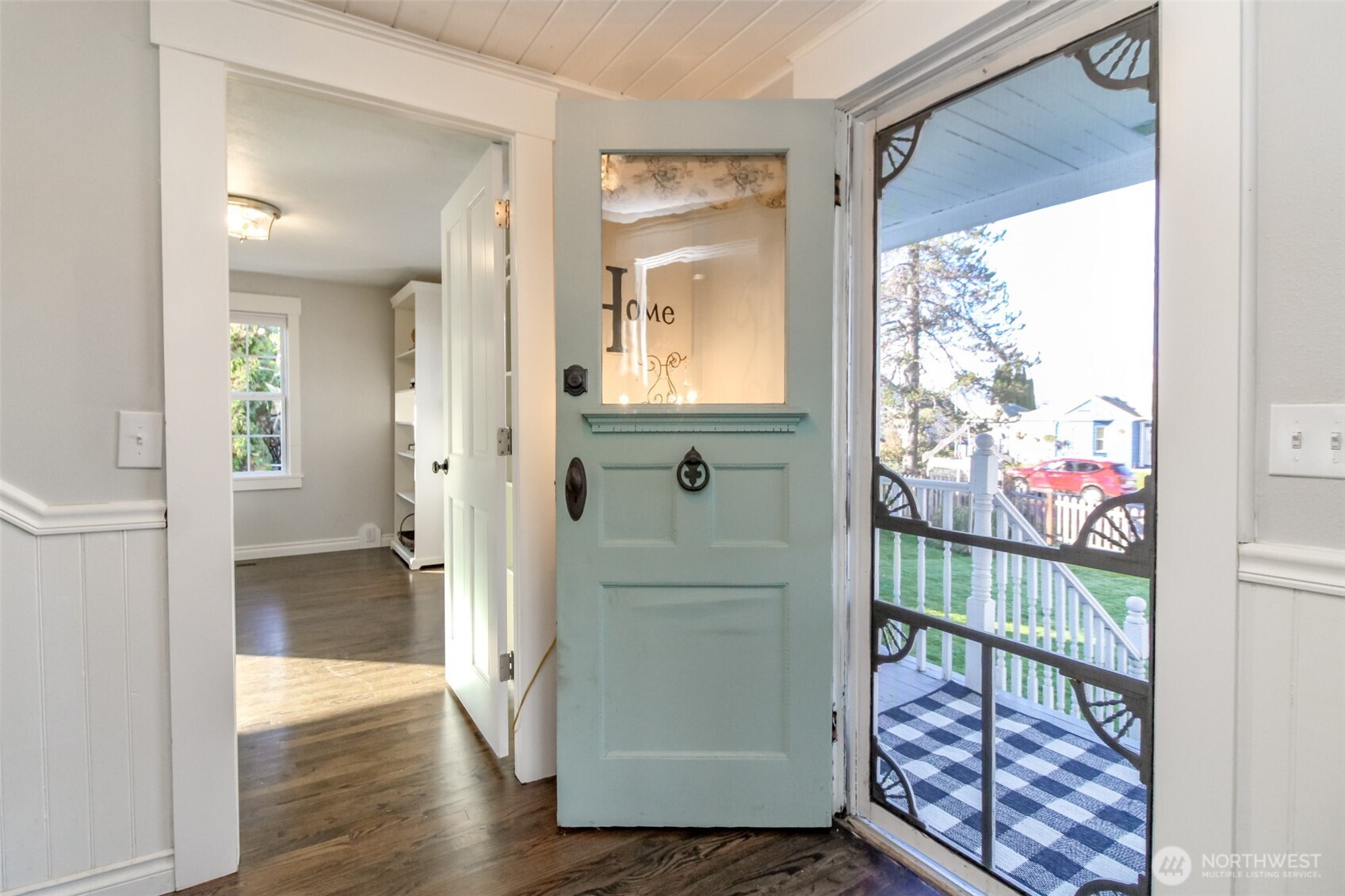 1514 Rainier Street Steilacoom, WA 98388 - Photo 4 of 37 a view of a hallway with wooden floor and a dining room