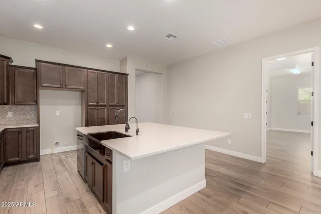a kitchen that has a sink and a refrigerator in it