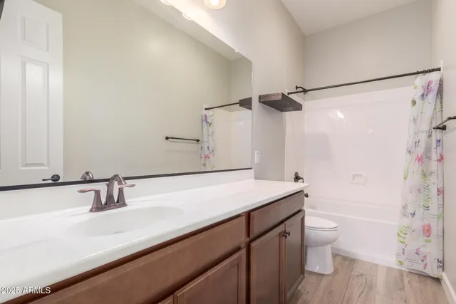 a bathroom with a sink a toilet a tub and shower