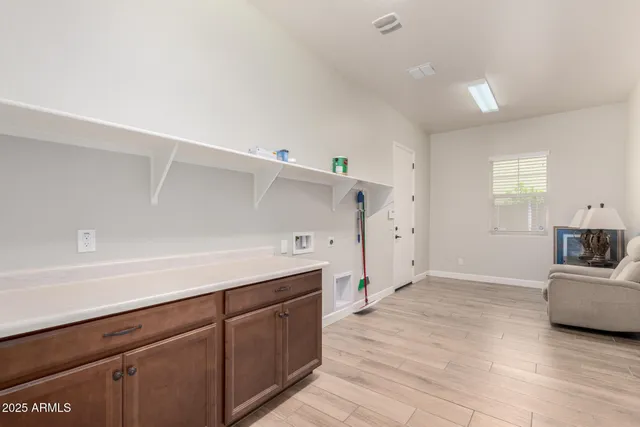 a view of a kitchen with furniture and wooden floor